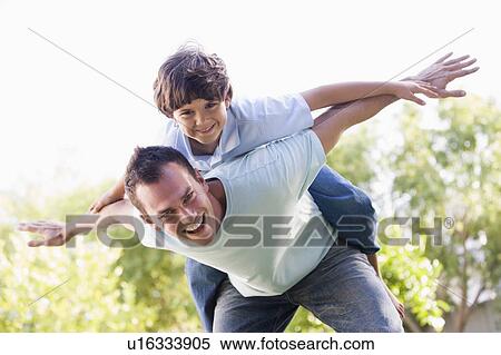 Man and young boy outdoors playing airplane smiling View Large Photo Image Stock Photography - Man and young boy outdoors playing airplane smiling. Fotosearch