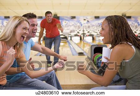 Man bowling with friends View Large Photo Image Stock Image - Man bowling with friends. Fotosearch