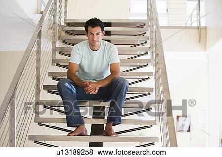 Stock Photo - Man sitting on staircase. Fotosearch