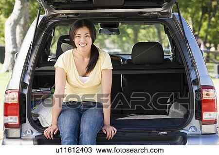 Woman sitting in back of van smiling View Large Photo Image Stock Image - Woman sitting in back of van smiling. Fotosearch