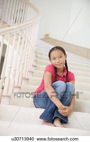 Young Girl Sitting On A Stairwell At Home View Large Photo Image Stock Image - Young Girl Sitting On A Stairwell At Home. Fotosearch