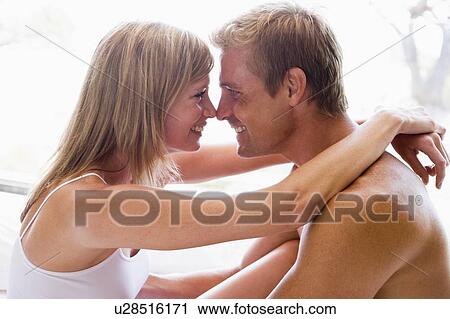 Couple in bedroom embracing and smiling View Large Photo Image Stock Image - Couple in bedroom embracing and smiling. Fotosearch