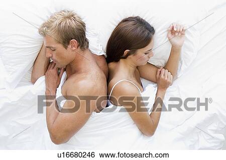 Couple lying in bed sleeping View Large Photo Image Stock Photograph - Couple lying in bed sleeping. Fotosearch