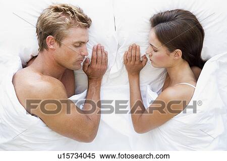 Stock Photography - Couple lying in bed sleeping. Fotosearch