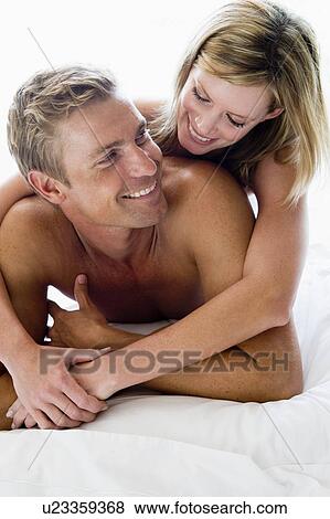 Couple lying in bed smiling View Large Photo Image Stock Photo - Couple lying in bed smiling. Fotosearch