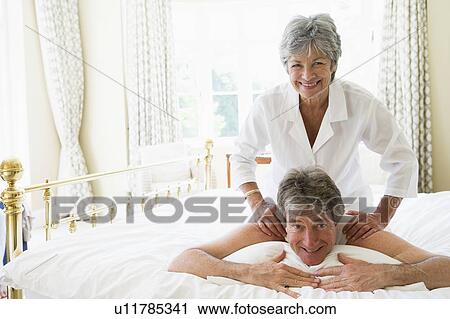 Stock Image - Man receiving a massage from a woman. Fotosearch