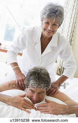 Man receiving a massage from a woman View Large Photo Image Stock Photo - Man receiving a massage from a woman. Fotosearch