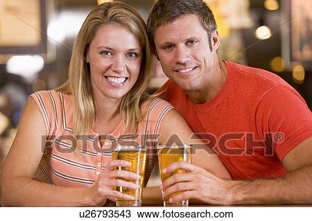 Stock Image - Couple having beer together. Fotosearch