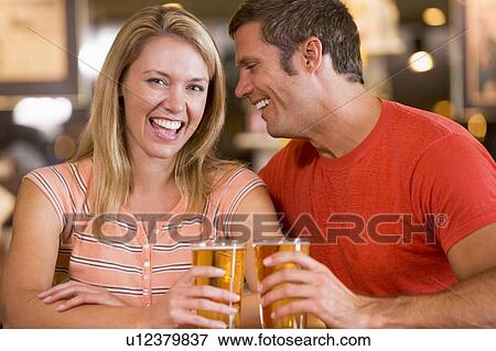 Couple having beer together View Large Photo Image Stock Photo - Couple having beer together. Fotosearch