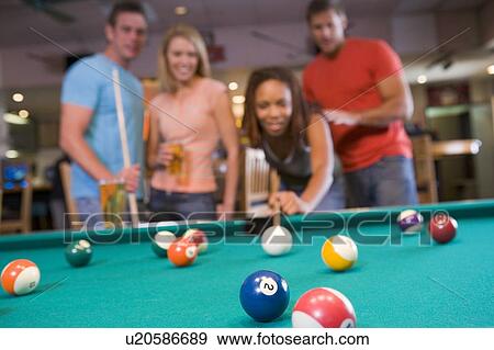 Friends playing pool View Large Photo Image Stock Photo - Friends playing pool. Fotosearch