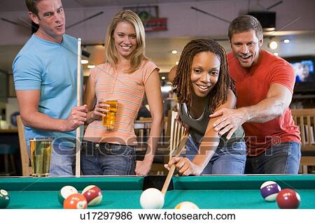 Stock Photograph - Friends playing pool. Fotosearch