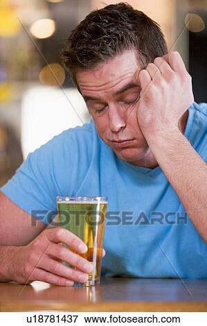 Innebriated man with glass of beer View Large Photo Image Stock Photo - Innebriated man with glass of beer. Fotosearch