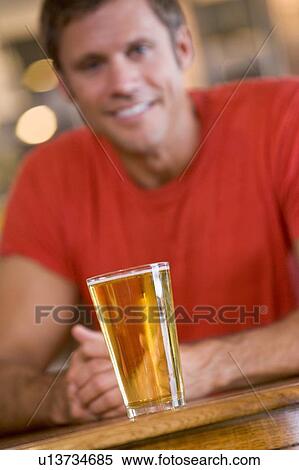 Stock Photography - Man having a glass of beer. Fotosearch