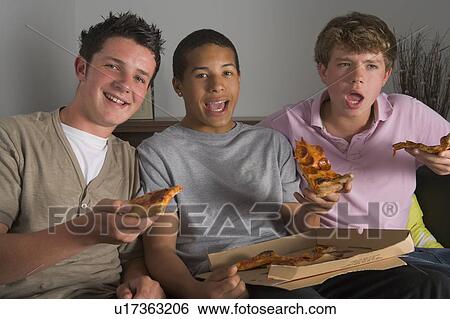 Stock Photograph - Teenage Boys Enjoying Pizza. Fotosearch