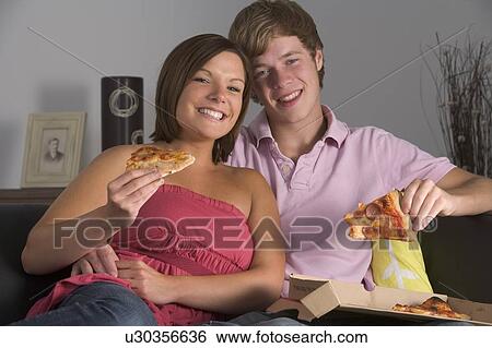 Stock Photograph - Teenage Couple Enjoying Pizza. Fotosearch