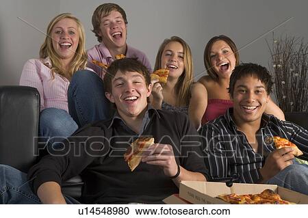 Stock Image - Teenagers Having Fun And Eating Pizza. Fotosearch