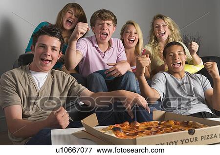 Stock Photo - Teenagers Having Fun And Eating Pizza. Fotosearch