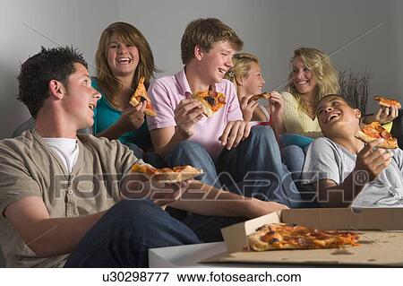 Stock Photo - Teenagers Having Fun And Eating Pizza. Fotosearch