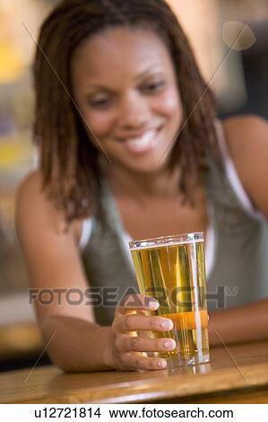 Picture - Two couples having beer together. Fotosearch