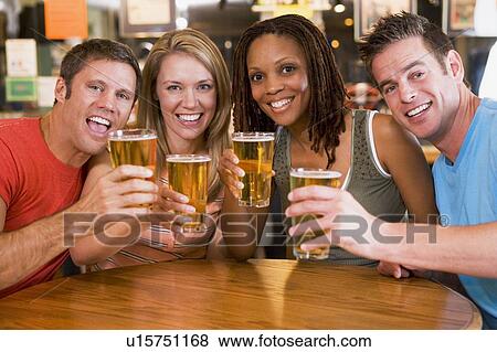 Stock Photo - Two couples having beer together. Fotosearch