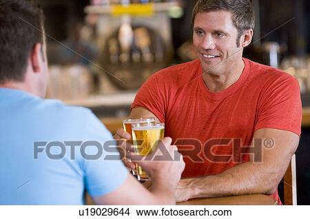 Two men having beer together View Large Photo Image Picture - Two men having beer together. Fotosearch