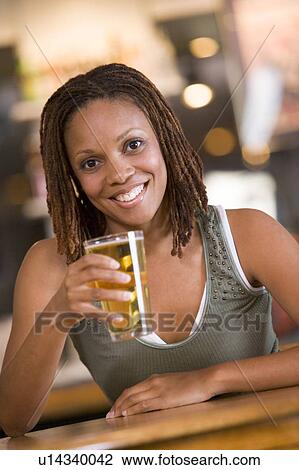 Woman having a glass of beer View Large Photo Image Stock Image - Woman having a glass of beer. Fotosearch