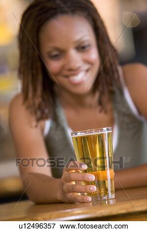 Woman having a glass of beer View Large Photo Image Stock Photo - Woman having a glass of beer. Fotosearch