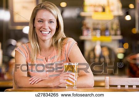 Woman having a glass of beer View Large Photo Image Stock Photography - Woman having a glass of beer. Fotosearch