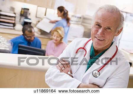 Picture - Doctors And Nurses At The Reception Area Of A Hospital. Fotosearch