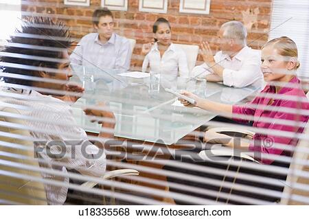 Five businesspeople in boardroom through window View Large Photo Image Stock Photo - Five businesspeople in boardroom through window. Fotosearch