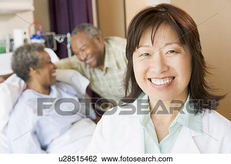 Stock Image - Nurse Smiling In Hospital Room. Fotosearch