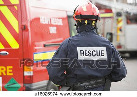 Picture - Rescue worker walking back to rescue vehicle. Fotosearch