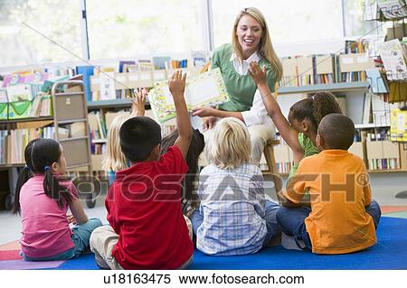 Stock Photography - Students in class volunteering for teacher. Fotosearch