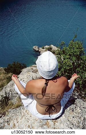 Woman outdoors doing yoga on cliff View Large Photo Image Stock Image - Woman outdoors doing yoga on cliff. Fotosearch