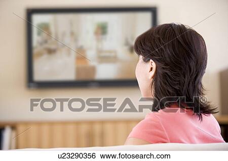 Woman watching television View Large Photo Image Stock Photograph - Woman watching television. Fotosearch