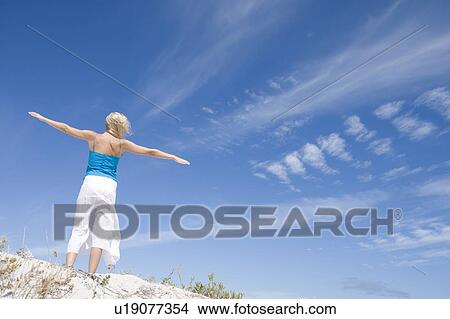 Picture - Young woman posing on a sand hill. Fotosearch