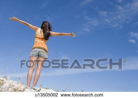 Young woman posing on a sand hill View Large Photo Image Stock Image - Young woman posing on a sand hill. Fotosearch