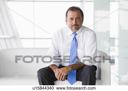 Businessman sitting indoors (high key/selective focus) View Large Photo Image Stock Image - Businessman sitting indoors (high key/selective focus). Fotosearch