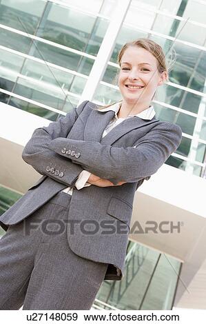 Stock Photo - Businesswoman standing outdoors smiling. Fotosearch