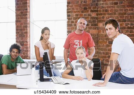 Five businesspeople in office space smiling View Large Photo Image Stock Photo - Five businesspeople in office space smiling. Fotosearch