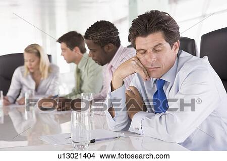 Four businesspeople in boardroom with one businessman sleeping View Large Photo Image Picture - Four businesspeople in boardroom with one businessman sleeping. Fotosearch