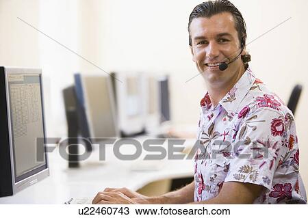 Man wearing headset in computer room smiling View Large Photo Image Stock Image - Man wearing headset in computer room smiling. Fotosearch