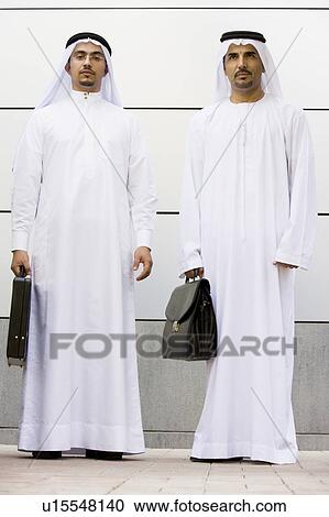 Two businessmen standing outdoors with briefcases View Large Photo Image Stock Image - Two businessmen standing outdoors with briefcases. Fotosearch