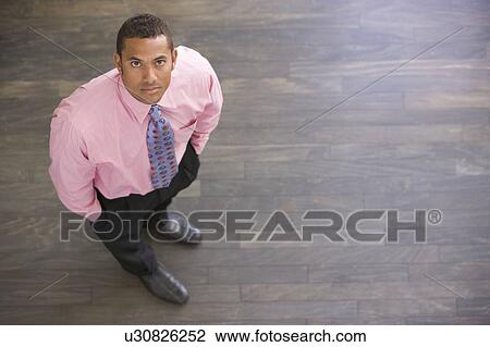 Businessman standing indoors View Large Photo Image Stock Image - Businessman standing indoors. Fotosearch