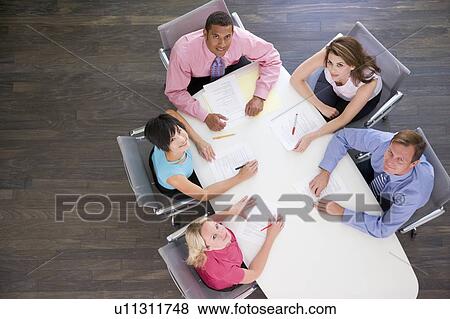 Five businesspeople at boardroom table View Large Photo Image Stock Photo - Five businesspeople at boardroom table. Fotosearch