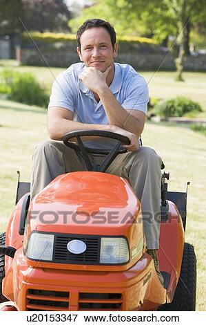 Stock Photo - Man outdoors on lawnmower smiling. Fotosearch