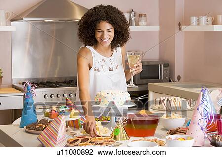 Woman at party getting tart from table smiling View Large Photo Image Stock Image - Woman at party getting tart from table smiling. Fotosearch