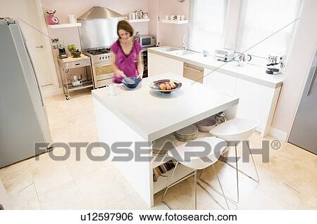 Woman in kitchen whisking on counter View Large Photo Image Stock Photograph - Woman in kitchen whisking on counter. Fotosearch
