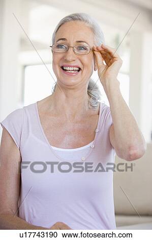 Stock Image - Woman Looking Through New Glasses. Fotosearch