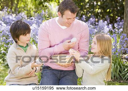 Father and two young children on Easter looking for eggs outdoors smiling View Large Photo Image Stock Photography - Father and two young children on Easter looking for eggs outdoors smiling. Fotosearch